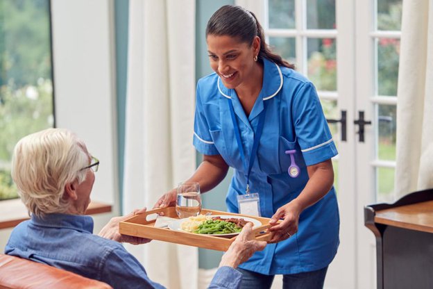 Shalom Care Solutions in Leicester, carer giving eldery man food
