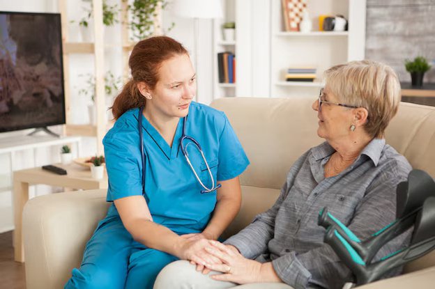 Newbirth Care, carer talking with client on the sofa