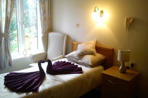 Finavon Court, bedroom with swan towels 