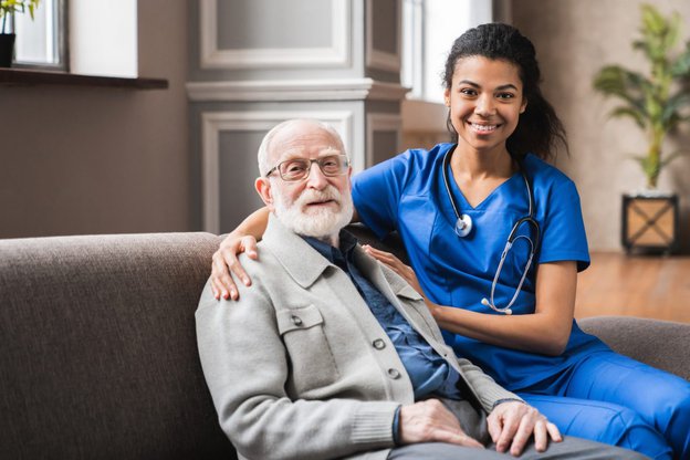 Lea Care in the Midlands carer sitting next to client