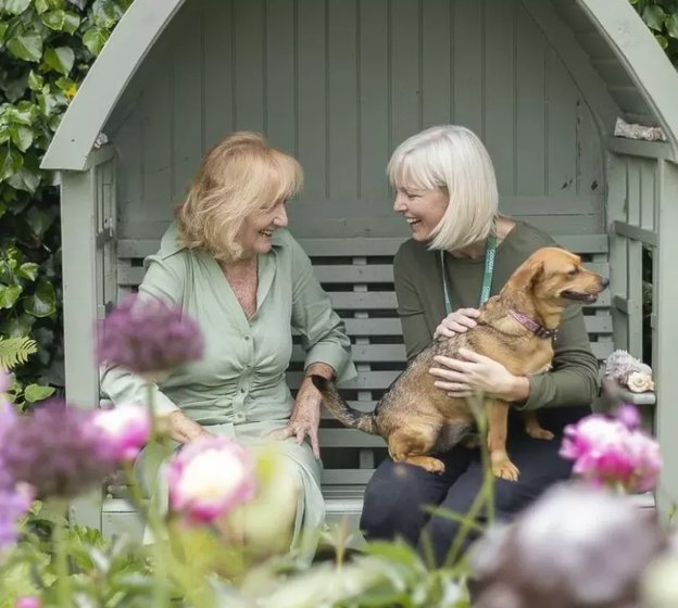 Carer talking to Eldering in the garden