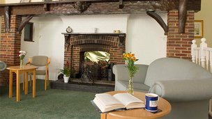 Haven Care Home in Peacehaven, lounge with fireplace