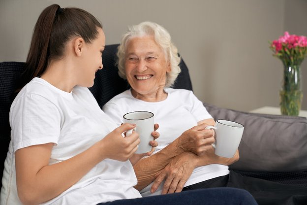 Live-in Care Direct nationwide, carer drinking tea with client