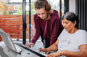 Home Instead Lichfield, Tamworth and North Warwickshire carer helping client use computer