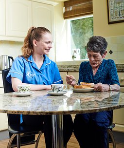 Bluebird Care Hounslow & Chiswick live in carer having tea with client