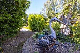 Llys Hafren Care Home - Garden with bird ornament