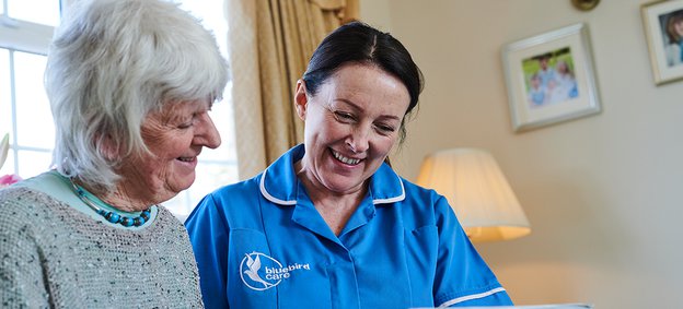 Bluebird Care Pontypridd Live in Carer reading with client