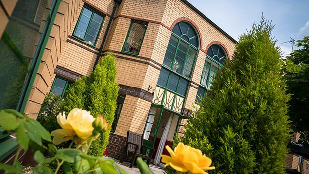 Magna Nursing Home, outside of the home with flowers 