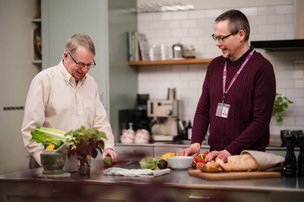 Home Instead Eastbourne and Hailsham carer cooking with client