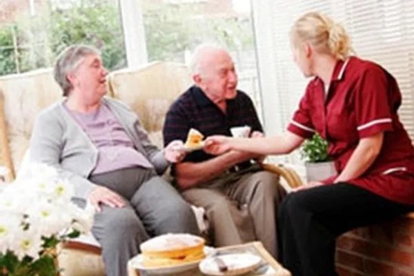 Meridian Community Care. Carer with elderly couple. 