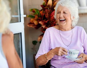 Novus Care, Cranleigh women laughing while having tea 