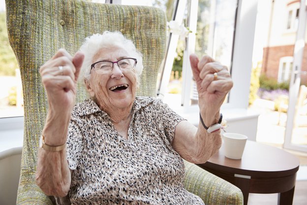 St Paul Care Support in England live in, lady in chair smiling