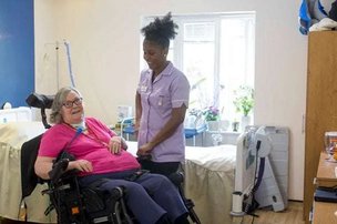 Highfield House, carer with elderly lady in a wheelchair. 