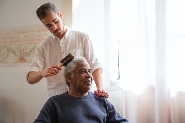 Sentimex Care carer combing gentlemans hair