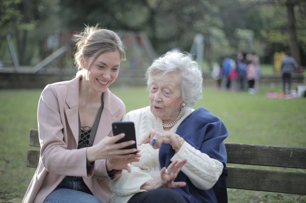 Temple Healthcare Ltd Carer with client in the park