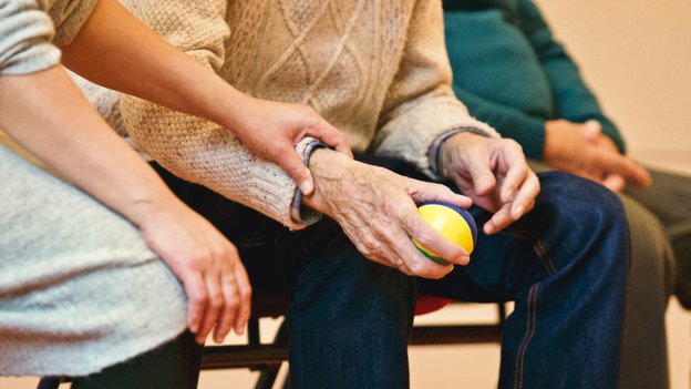 Phare Care, man using an exercise ball. 