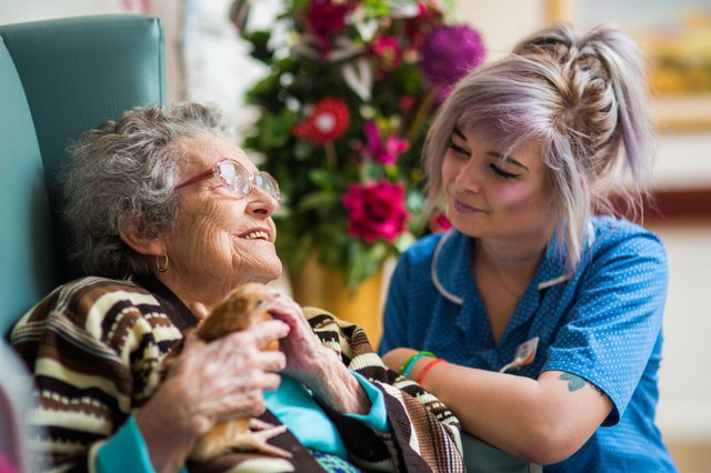 Bedford Care Home, carer with eldery lady 