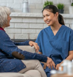 Profound Care, carer speaking with elderly lady. 