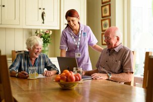 Radfield Home Care Bath, Keynsham & Radstock. Carer sitting with an eldery couple  