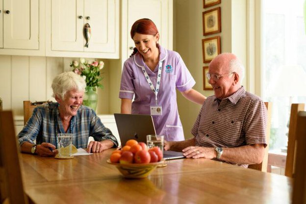 Radfield Home Care Bath, Keynsham & Radstock. Carer with eldery couple at the table 