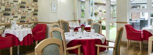 Tremona Care Home in Watford, red dining area 