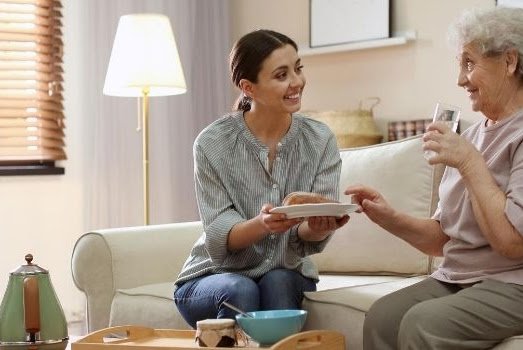 Rising Star In Rainham - Carer having Meal with service user