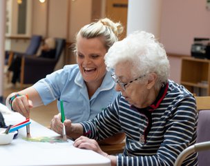 Rotherlea - carer helping resident with activity