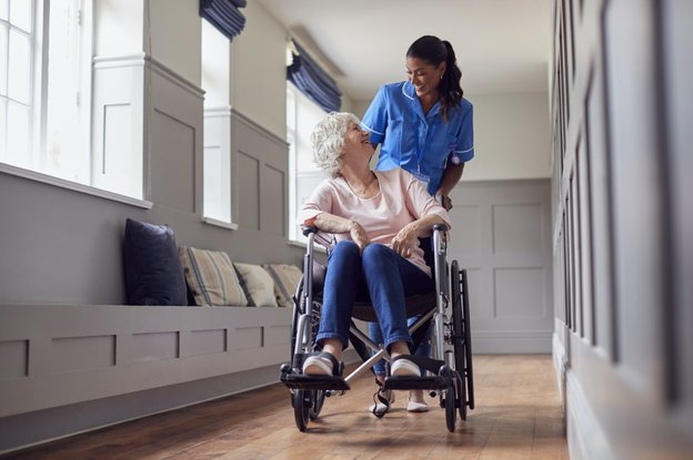 Enigma Clinical Solutions lady in a wheelchair with carer