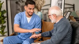 St Annes Nursing Home. Carer holding elderly mans hand 