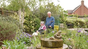 Sycamore Lodge - Resident with visitor enjoying the garden