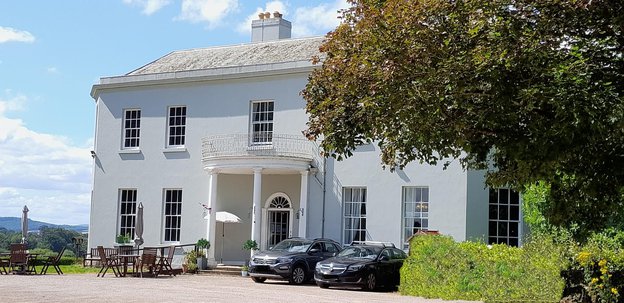 The Weir Nursing Home, cars outside front of home. 