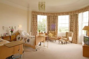 The Weir Nursing Home, large room with beige carpet. 