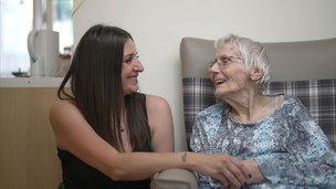 The Martlets - resident smiling at visitor