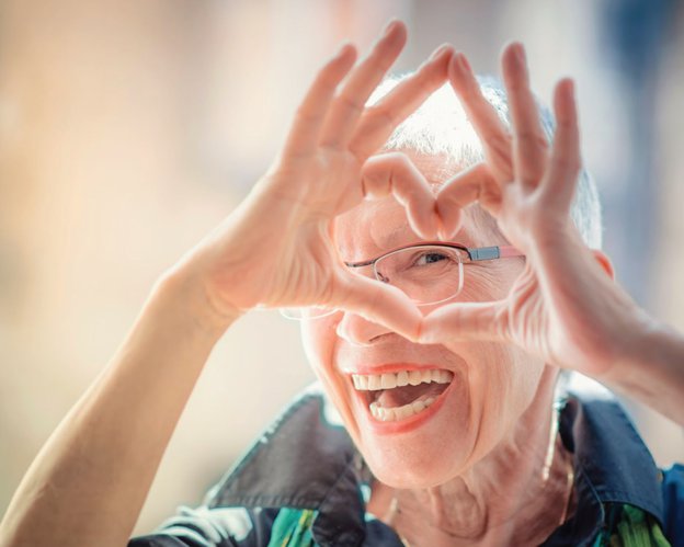 Apollo Care Blackpool live in lady making a heart with her hands