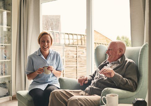 Verified Care and Support. Carer sitting with eldery man 