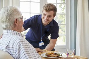 Visiting Angels Central Surrey, carer helping eldery man prepare meal. 