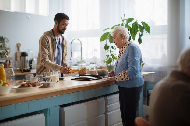 Carer helping make food for elderly